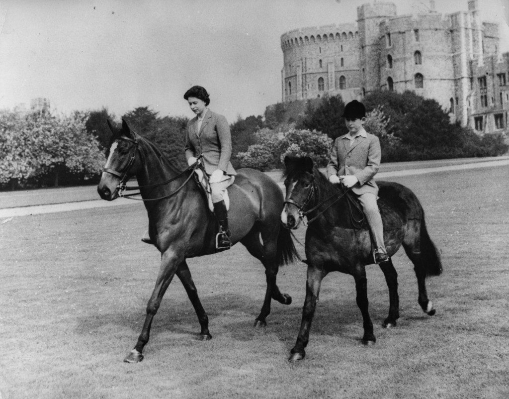 Queen Elizabeth II and her son, the Prince of Wales, out riding at Windsor Castle