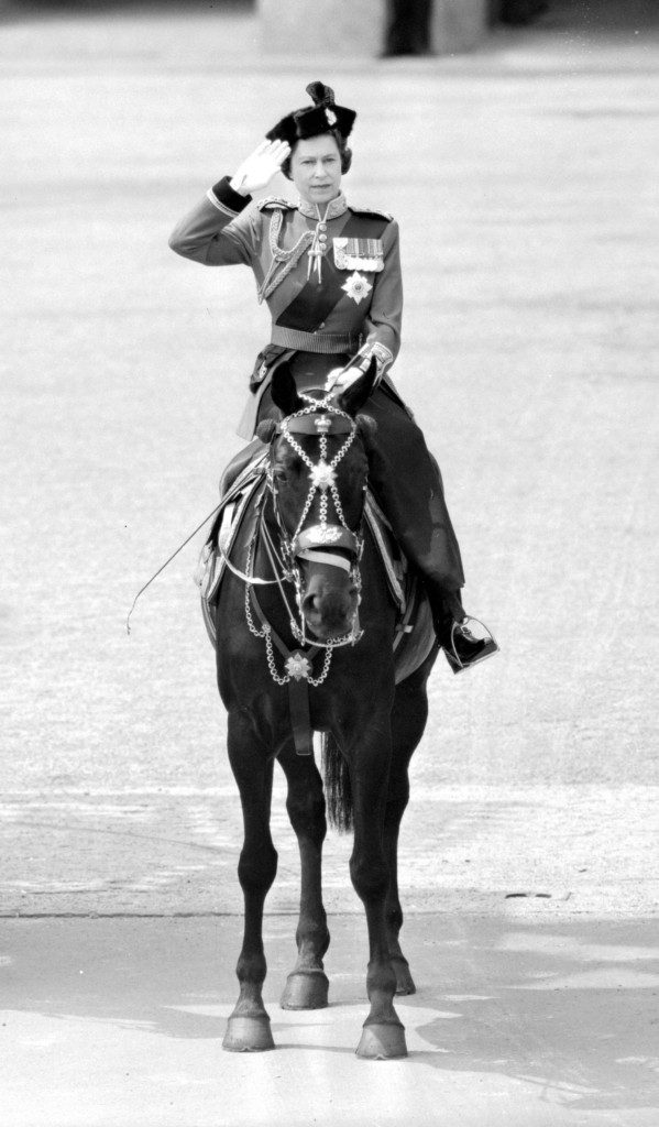 The Queen taking the salute as the Scots Guards marched past at Buckingham Palace after the Trooping the Colour ceremony, mounted on Burmese, the black mare presented to her by the Royal Canadian Mounted Police