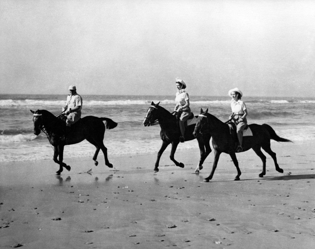 The Princesses enjoyed an off-duty break from the royal tour of South Africa when they went riding on the golden sands of Bonza Beach, East London, Princess Elizabeth (centre) is riding Yvonne Hayhoe's 'Jill" while Princess Margaret rides 'Treasure' owned by Pat O'Reilly of East London, who is seen escorting the Princesses.