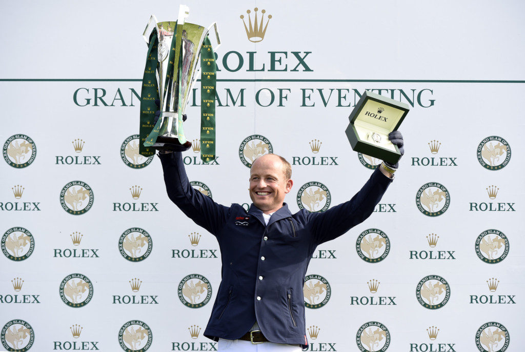 Michael Jung with his trophy for his Rolex Grand Slam of Eventing, and his new Rolex watch. Photo Rolex / Kit Houghton