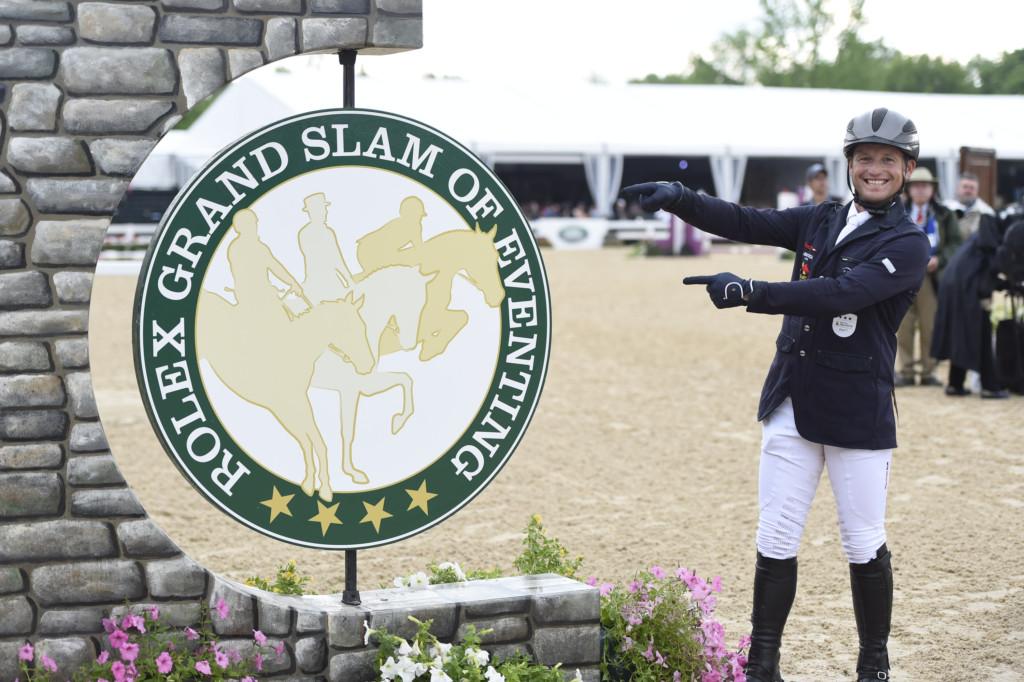 Michael Jung points to the Rolex Grand Slam of eventing sign. Will he win it next week? Photo Rolex / Kit Houghton