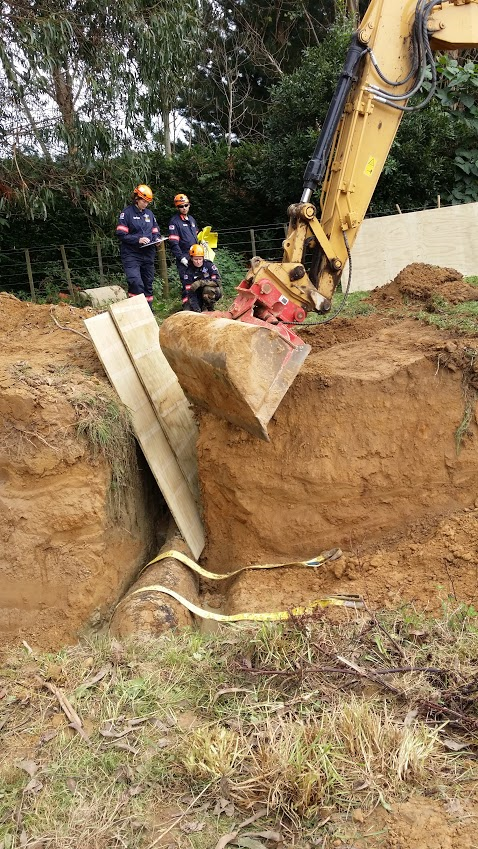 Boards had to be used to protect Justin from any falling dirt, while it was carefully moved away from him.