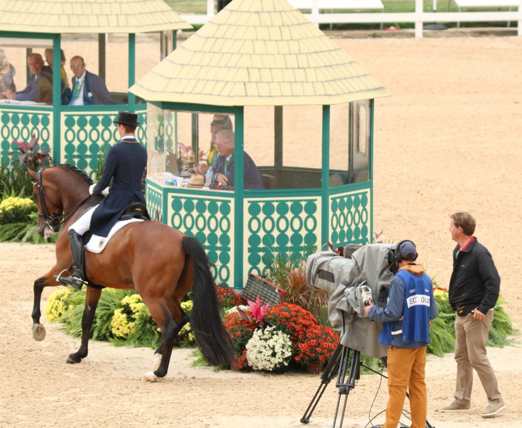 Sonke Rothenberger heads towards the arena. You can just make out NZer Andrew Bennie in the first judges box, he is a writer for the dressage. (Image: Jane Thompson) 