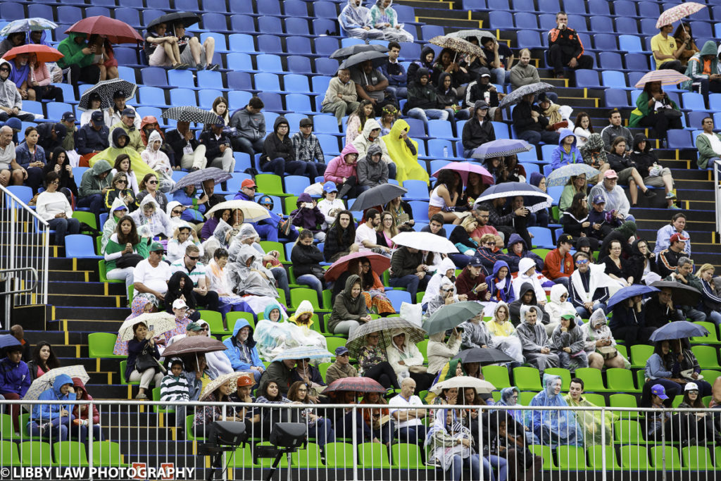 The specatators take cover as the rain comes down during the Grand Prix Special (Image: Libby Law)