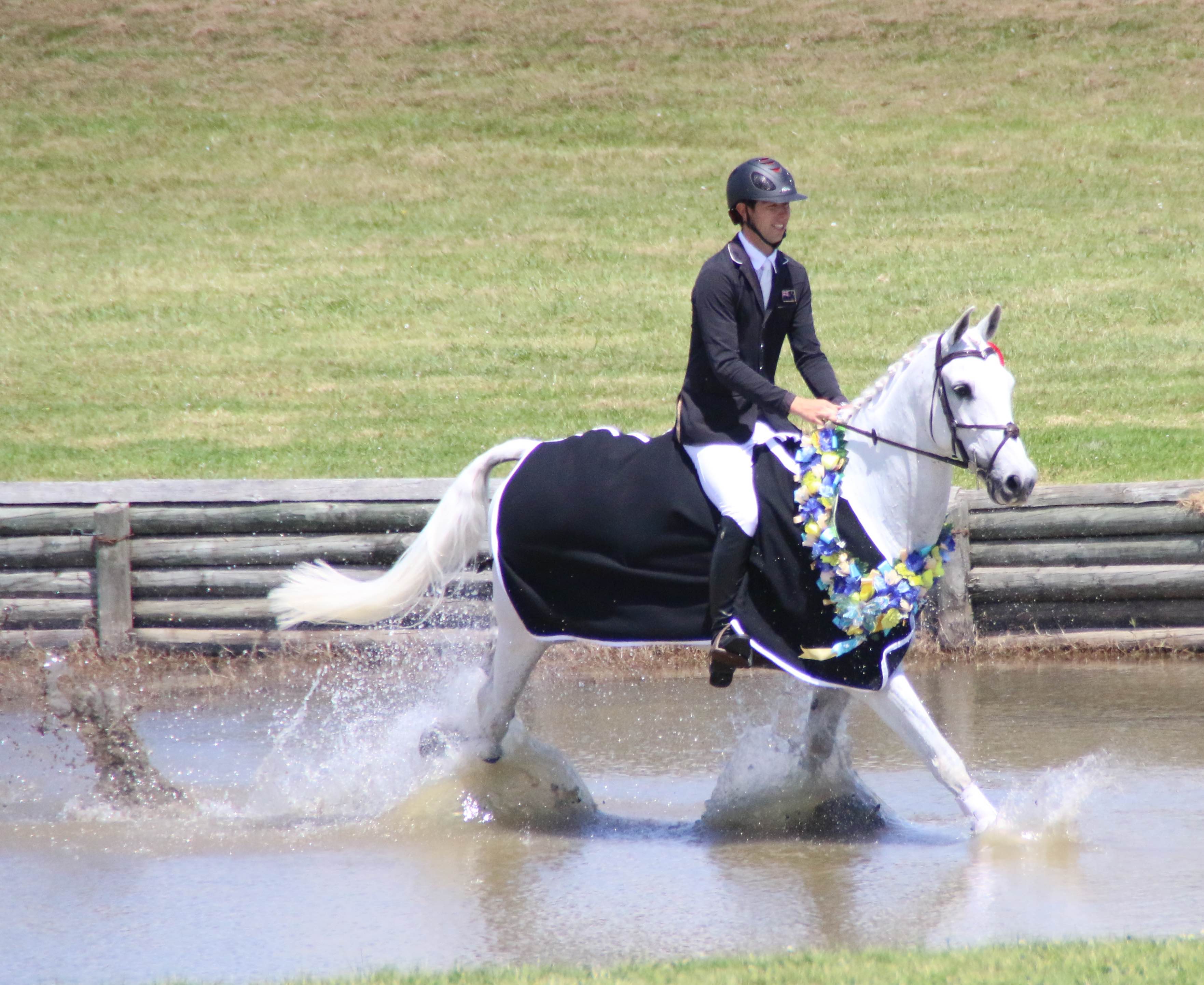 Clarke and Balmoral Sensation doing the traditional victory lap through the water jump